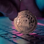 Aave,Cryptocurrency,Physical,Coin,Placed,On,Laptop,Keyboard,And,Lit